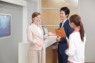 AEON teacher doing lobby talk with two students. One of her business responsibilities.